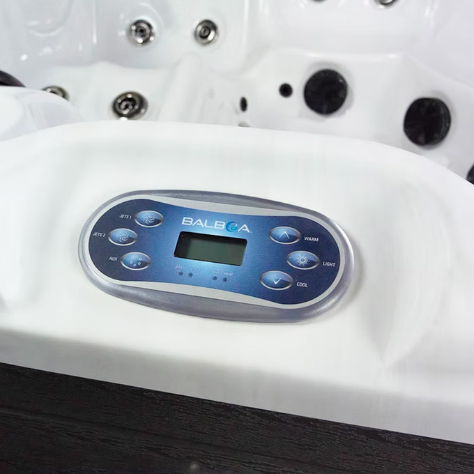 White balboa hot tub control panel with blue buttons and a digital display.