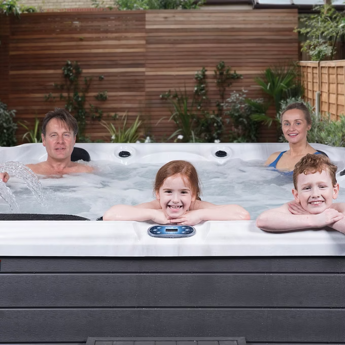 White and black outdoor hot tub with a digital control panel