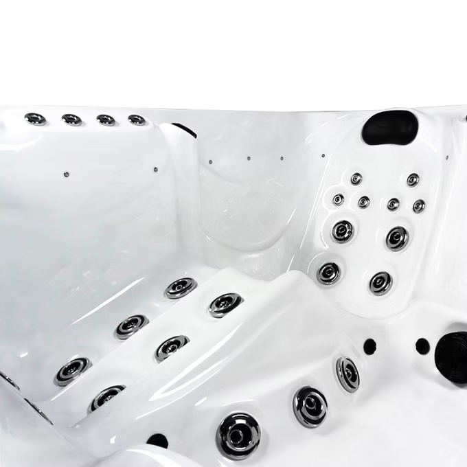 White hot tub with chrome jets and black accent panels.