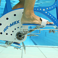 White and blue underwater exercise bike with metallic pedals and frame.