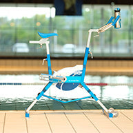 Blue and white stationary exercise bike with adjustable handlebars and a padded seat