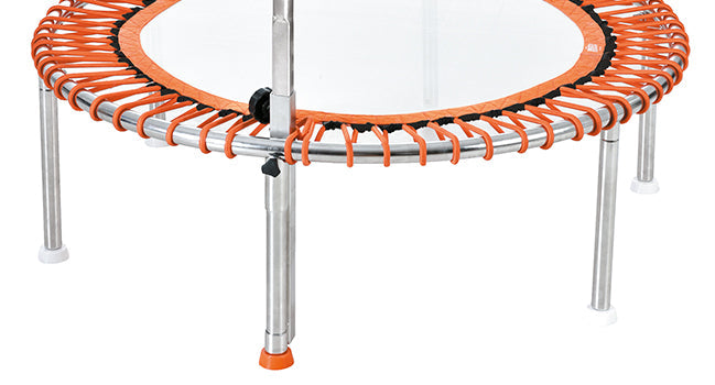 Orange and silver mini trampoline with a circular frame, metal legs, and safety padding